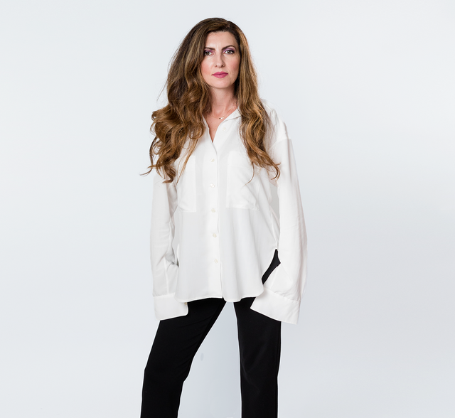woman wearing a sustainable crepe blouse in ivory
