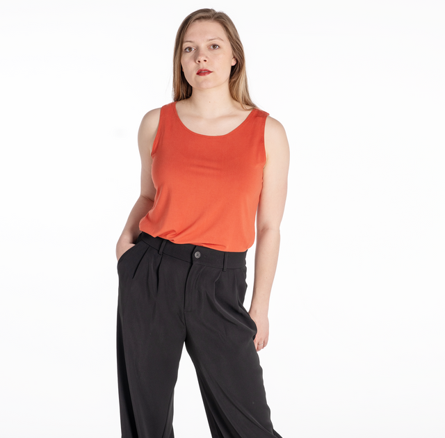 woman wearing a persimmon bamboo tank top with side slit