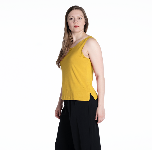 woman wearing a citrine yellow bamboo tank top with side slit