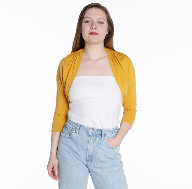 woman wearing a citrine yellow three-quarter sleeve bamboo shrug