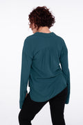 back detail woman wearing a sustainable crepe blouse in teal