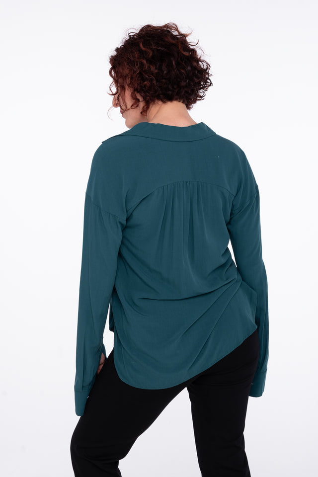 back detail woman wearing a sustainable crepe blouse in teal