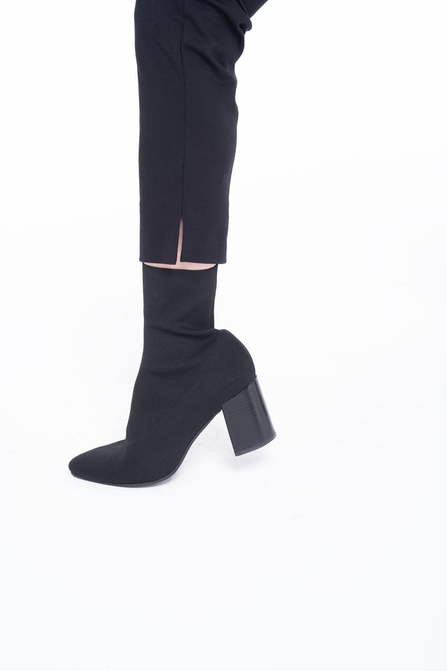 detail of cropped black Ponte pant with 3" inseam slit