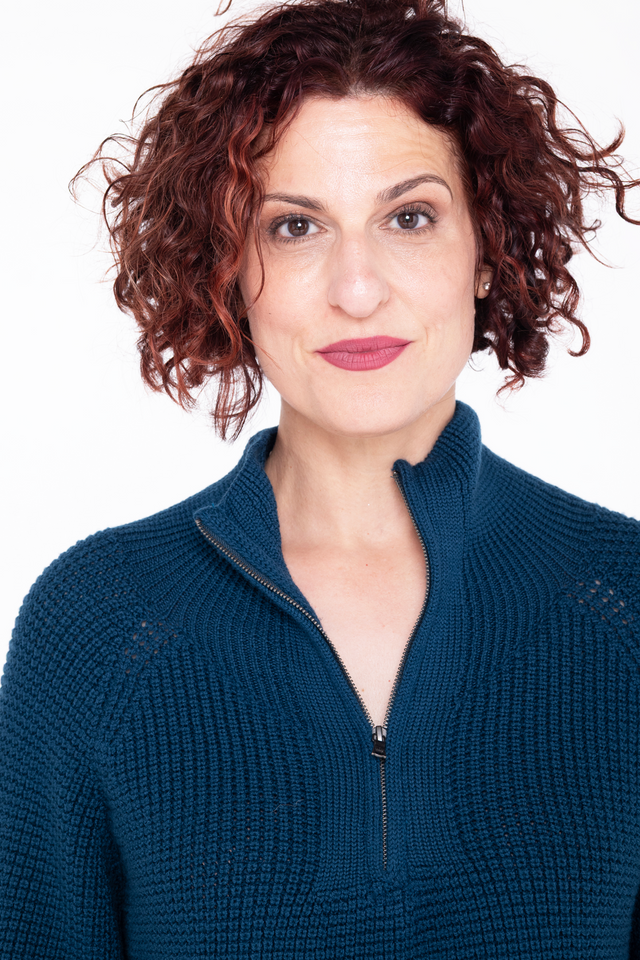 detail of woman wearing teal merino wool 3/4 zip sweater