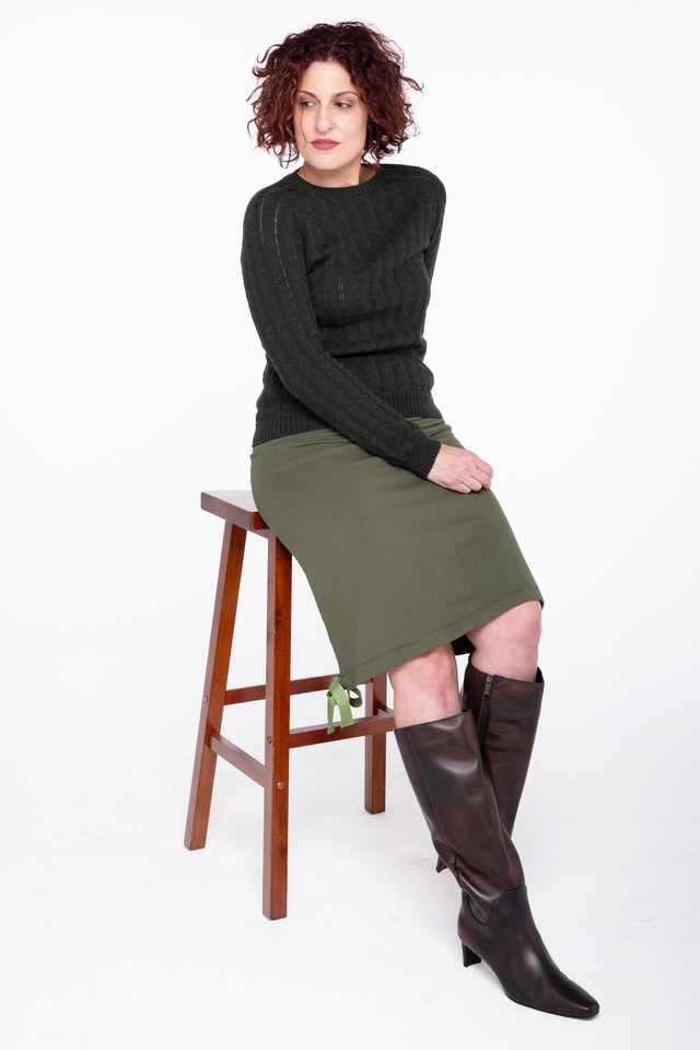 woman wearing a fern green french terry skirt with a ribbon hem detail